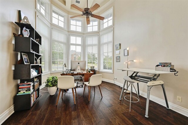 office with ceiling fan, a high ceiling, and dark hardwood / wood-style floors