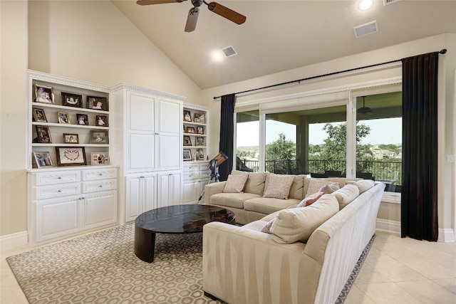 living room featuring ceiling fan, light tile floors, and high vaulted ceiling