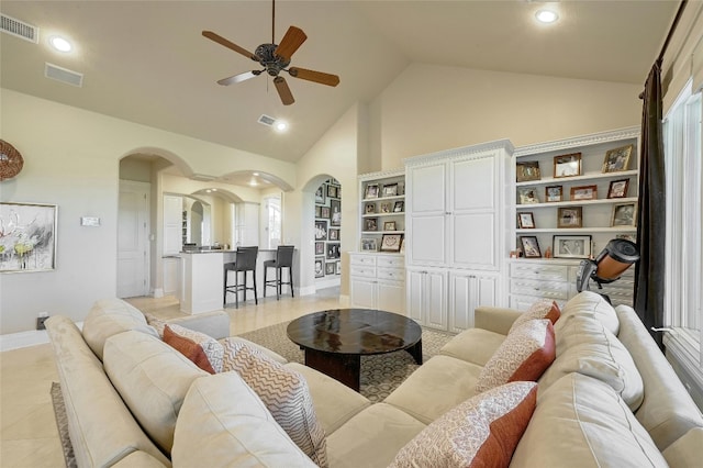 living room featuring high vaulted ceiling, ceiling fan, and light tile floors