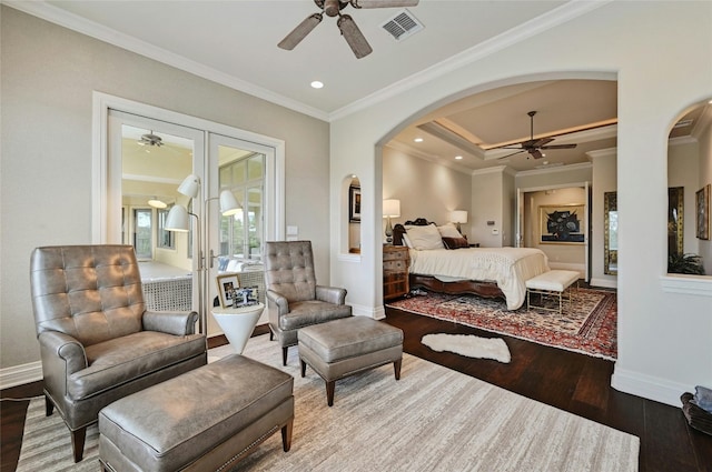 bedroom featuring french doors, ornamental molding, and dark wood-type flooring