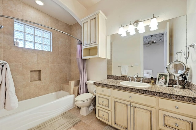 full bathroom with toilet, ceiling fan, vanity, shower / bath combination with curtain, and tile floors