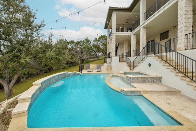 view of swimming pool with a patio, ceiling fan, a yard, and an in ground hot tub