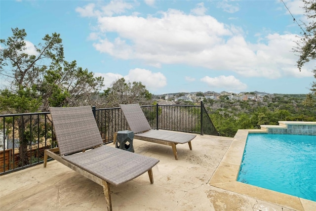 view of swimming pool featuring a patio area