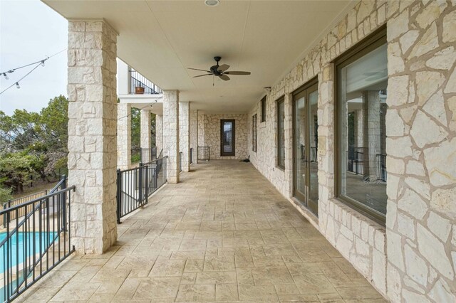 view of patio / terrace featuring ceiling fan and a fenced in pool