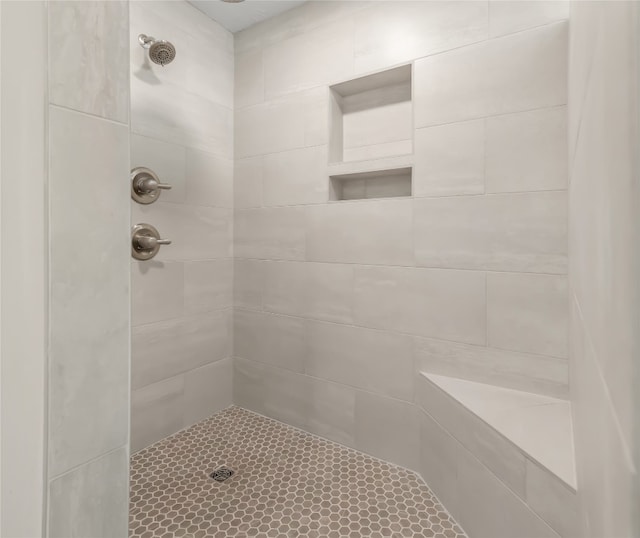 bathroom with a tile shower