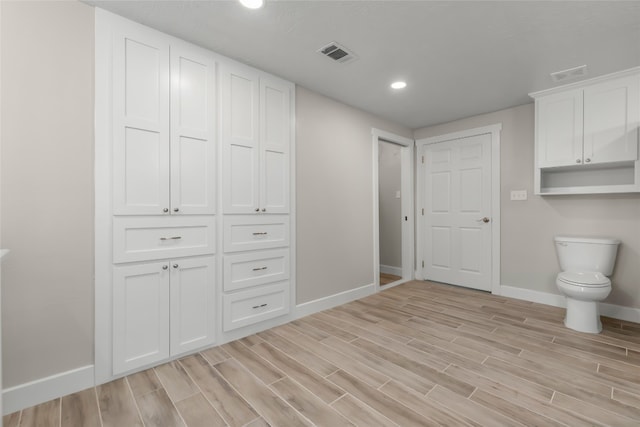 bathroom featuring toilet and hardwood / wood-style flooring