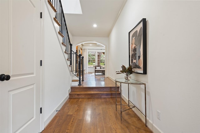 hall with dark hardwood / wood-style flooring, crown molding, and french doors