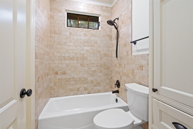 bathroom featuring toilet and tiled shower / bath combo