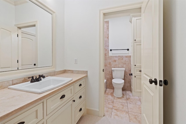 bathroom with toilet, tile patterned floors, and vanity