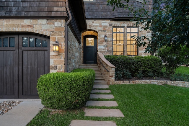 doorway to property featuring a lawn