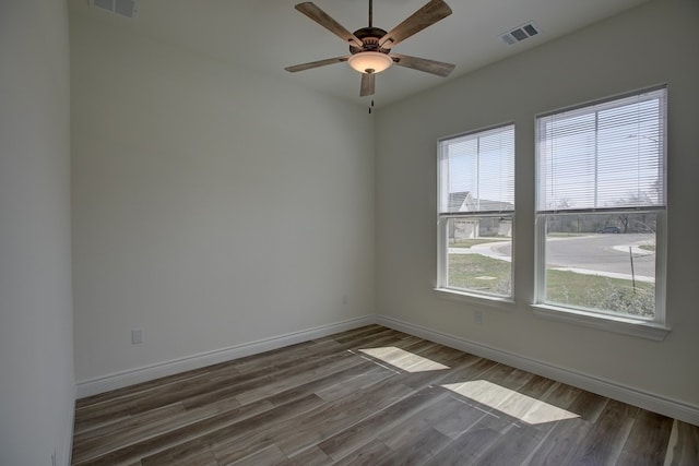 unfurnished room with ceiling fan and dark hardwood / wood-style floors