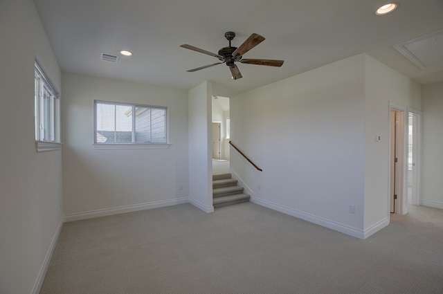 interior space with ceiling fan and light colored carpet