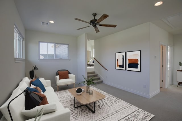 living room with light colored carpet and ceiling fan