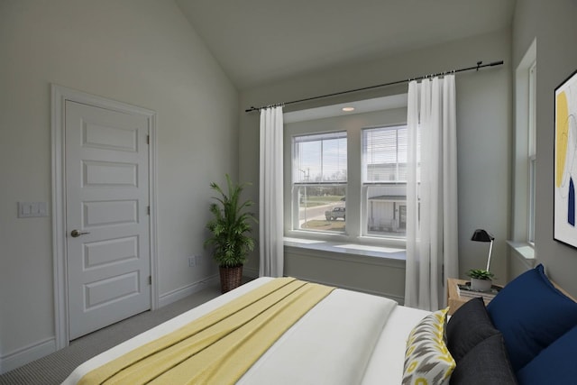 carpeted bedroom featuring vaulted ceiling