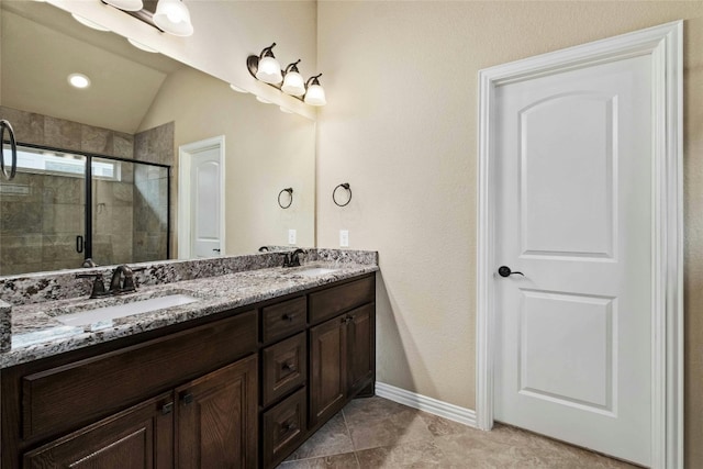 bathroom with tile floors, an enclosed shower, vaulted ceiling, and dual bowl vanity