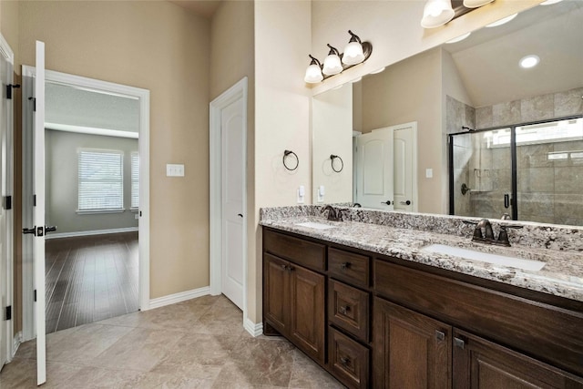 bathroom featuring a healthy amount of sunlight, dual sinks, vanity with extensive cabinet space, and tile flooring