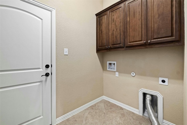 laundry area featuring light tile floors, hookup for a washing machine, gas dryer hookup, hookup for an electric dryer, and cabinets