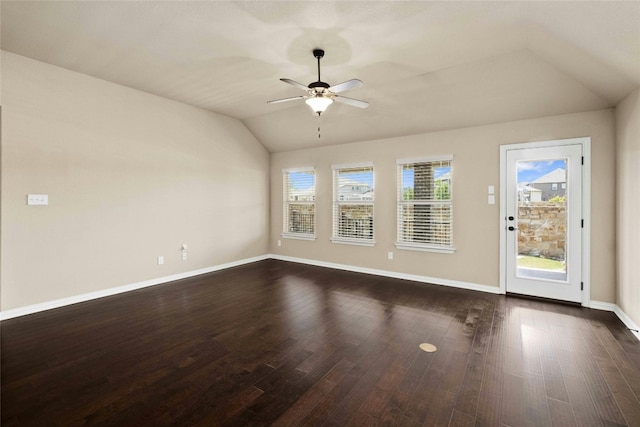 empty room featuring ceiling fan, dark wood-type flooring, and vaulted ceiling