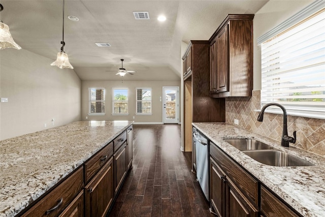 kitchen featuring ceiling fan, backsplash, hanging light fixtures, dark hardwood / wood-style floors, and sink