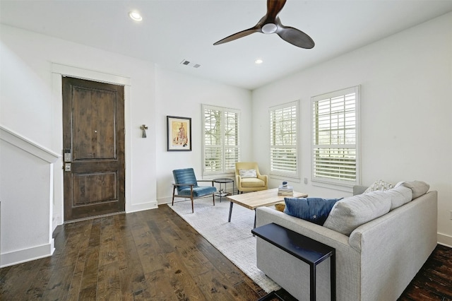 living room featuring ceiling fan and dark hardwood / wood-style floors