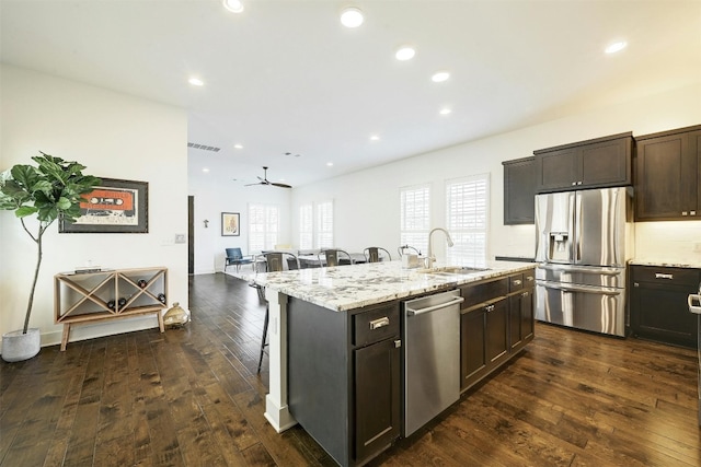 kitchen with ceiling fan, appliances with stainless steel finishes, sink, dark brown cabinetry, and dark hardwood / wood-style flooring