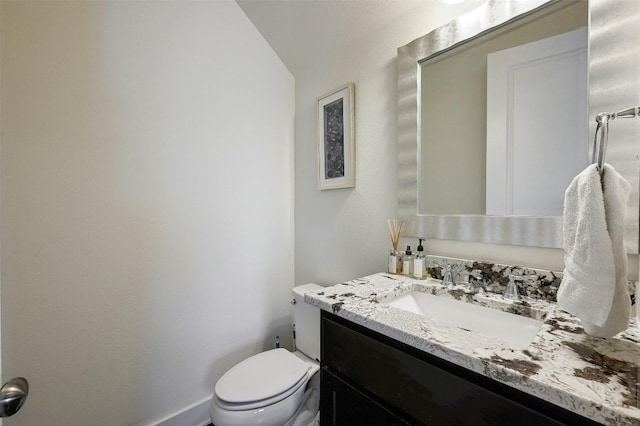 bathroom featuring toilet and large vanity