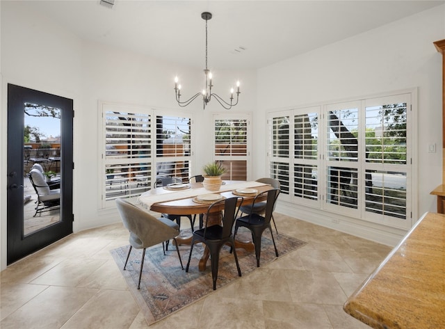 dining area with an inviting chandelier and light tile floors