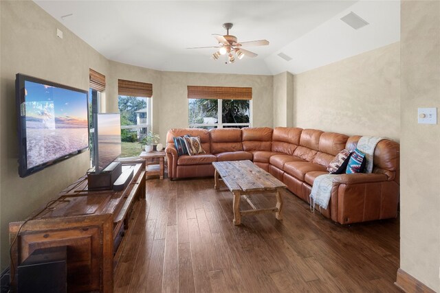 living room with ceiling fan, dark wood-type flooring, and lofted ceiling