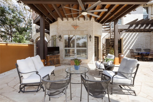 view of patio with area for grilling, ceiling fan, and an outdoor hangout area