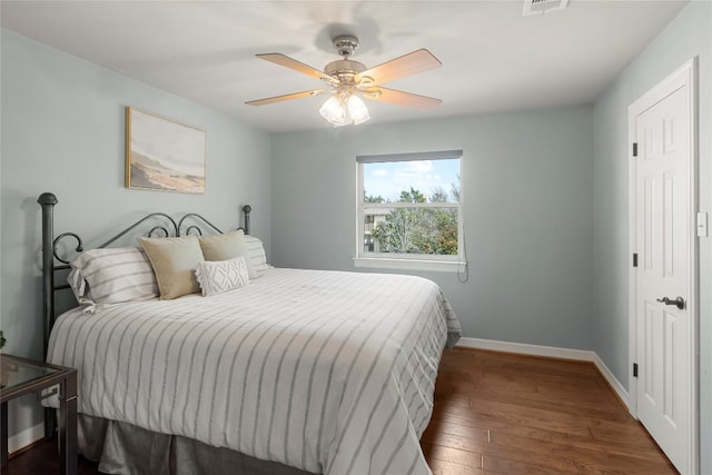 bedroom with ceiling fan and dark hardwood / wood-style flooring