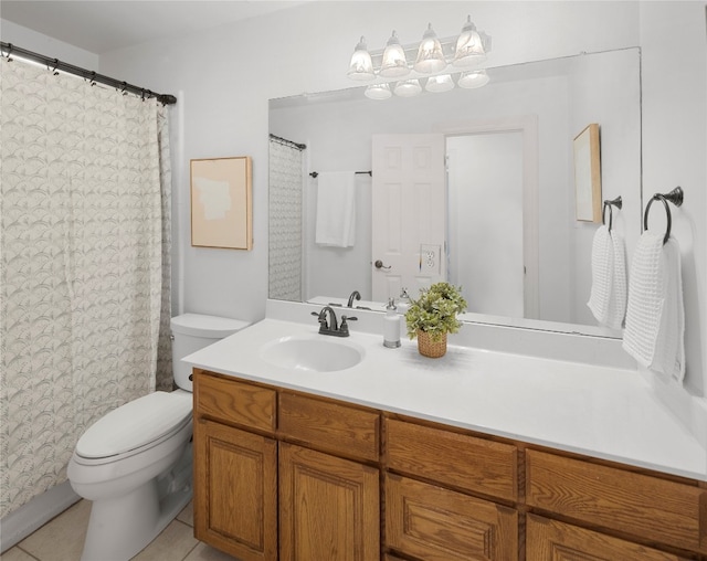 bathroom featuring tile floors, vanity with extensive cabinet space, and toilet