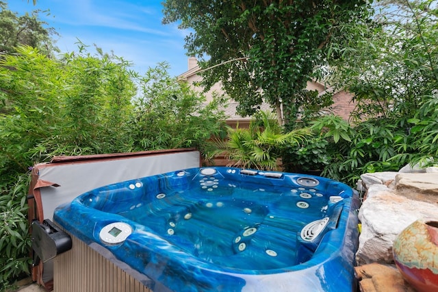 view of pool with a hot tub