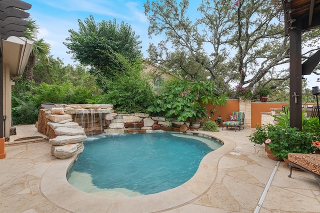 view of swimming pool featuring pool water feature and a patio area