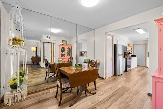 dining space featuring light hardwood / wood-style flooring