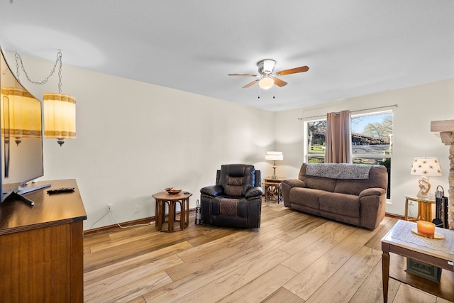 living room featuring ceiling fan and light hardwood / wood-style floors