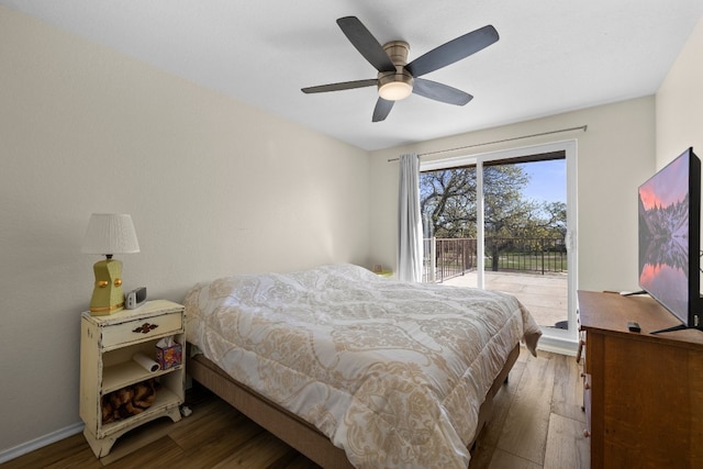 bedroom with access to exterior, ceiling fan, and dark wood-type flooring