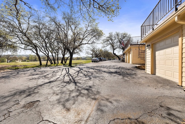 view of yard with a balcony and a garage