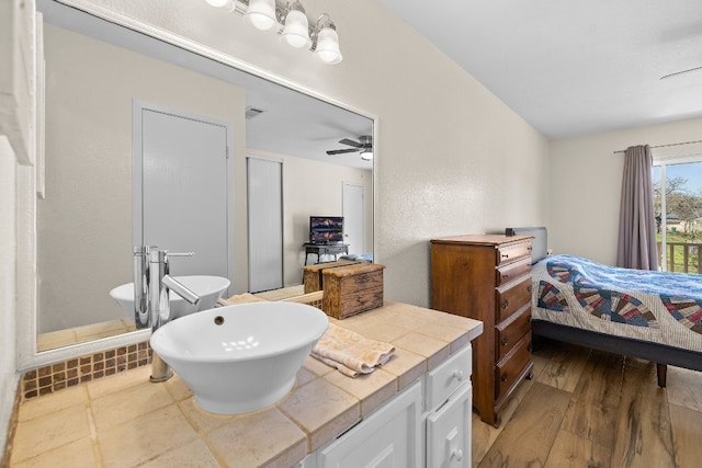 bathroom with ceiling fan, vanity, and hardwood / wood-style flooring