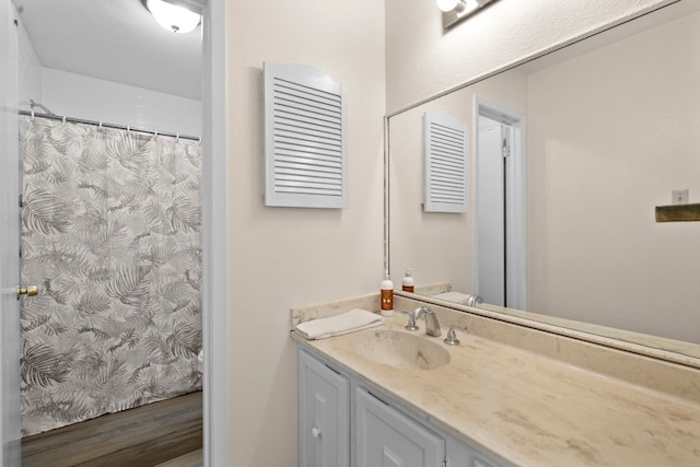 bathroom featuring hardwood / wood-style floors and oversized vanity