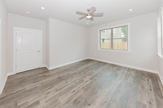 unfurnished room with ceiling fan and light hardwood / wood-style flooring