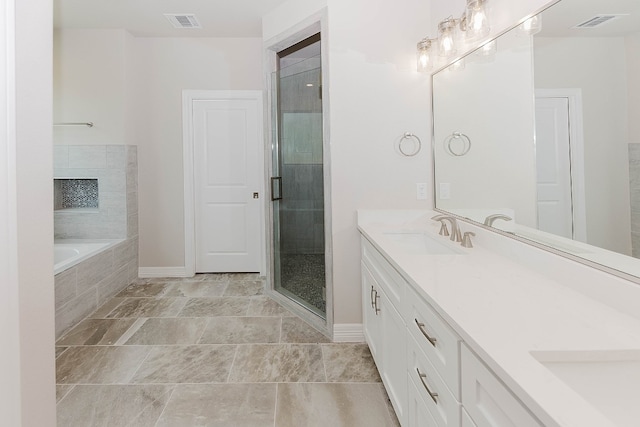 bathroom with vanity and independent shower and bath