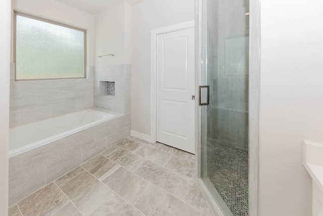 bathroom with separate shower and tub