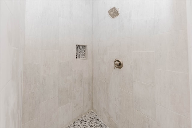 bathroom with tiled shower