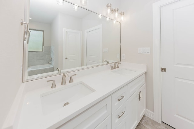 bathroom featuring a bathing tub, tile patterned flooring, and vanity