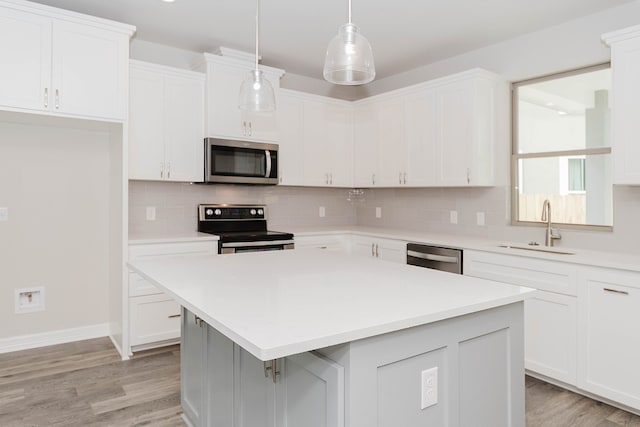 kitchen featuring white cabinetry, a center island, and appliances with stainless steel finishes