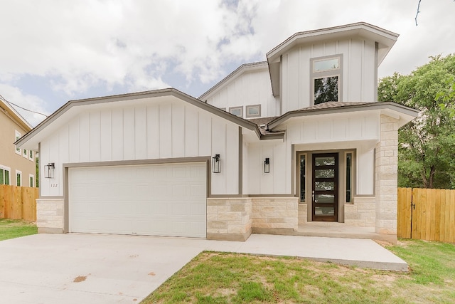 modern farmhouse featuring a garage and a front yard