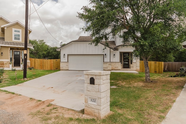 view of front of property featuring a garage and a front lawn