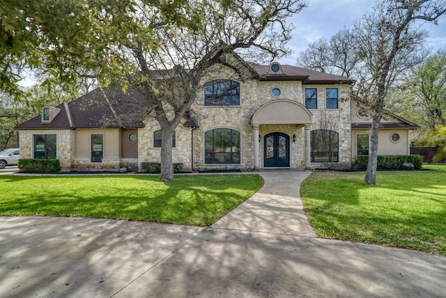 french country home featuring a front yard