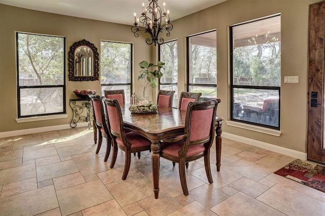 tiled dining room with a notable chandelier