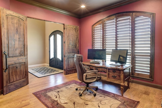 home office with crown molding and light hardwood / wood-style flooring